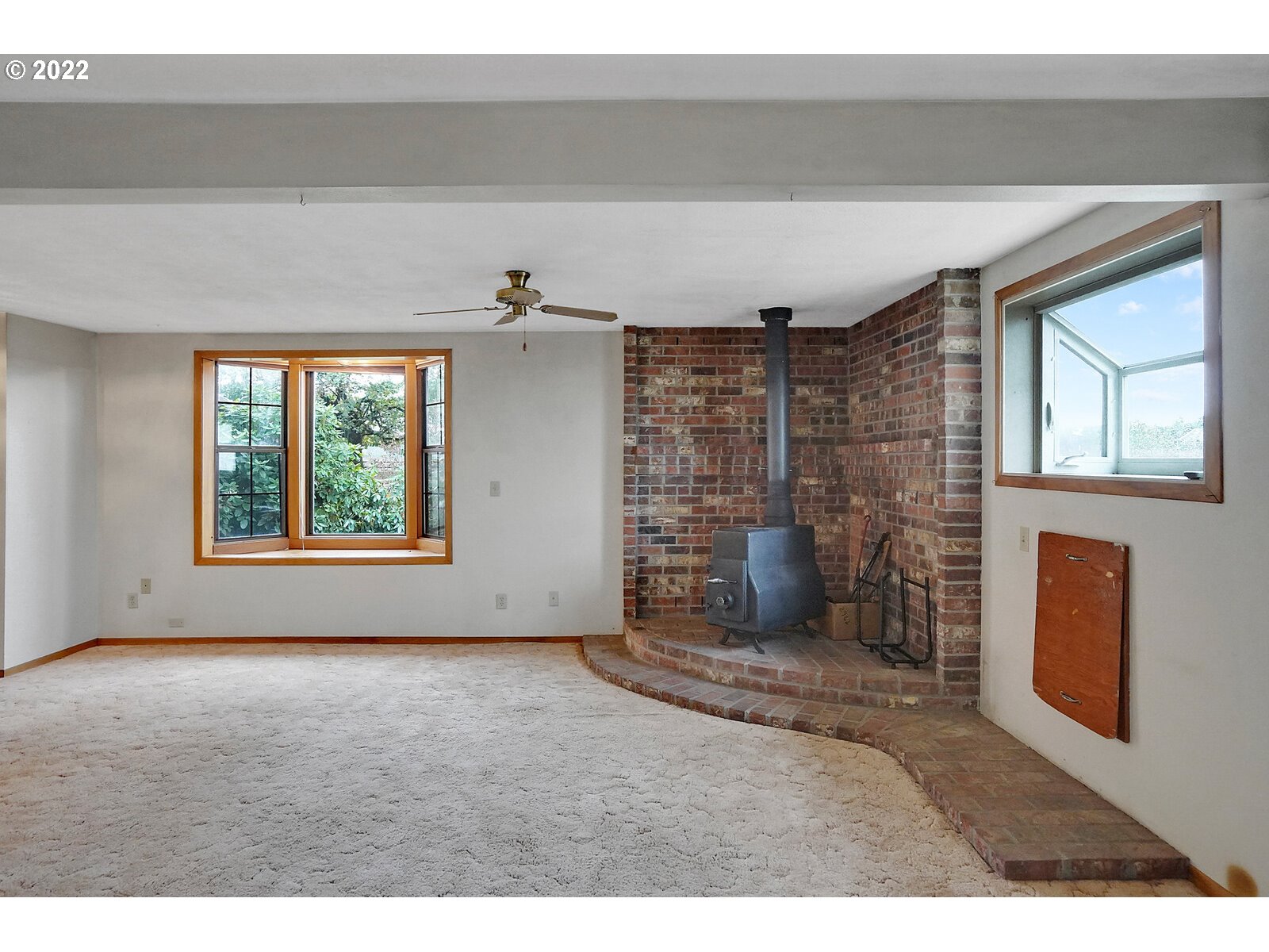 11145 Whiteaker Road Dallas, OR 97338 - Photo 18 of 32 a view of empty room with a fireplace and windows