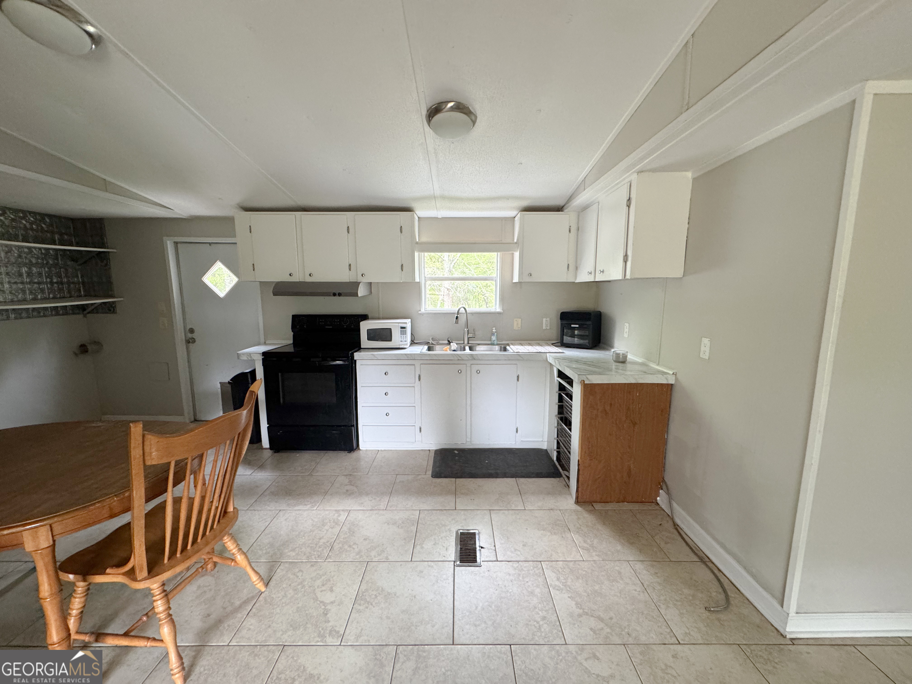 877 West Rushing Road Register, GA 30452 - Photo 11 of 18 a kitchen with a cabinets a sink and a counter top space