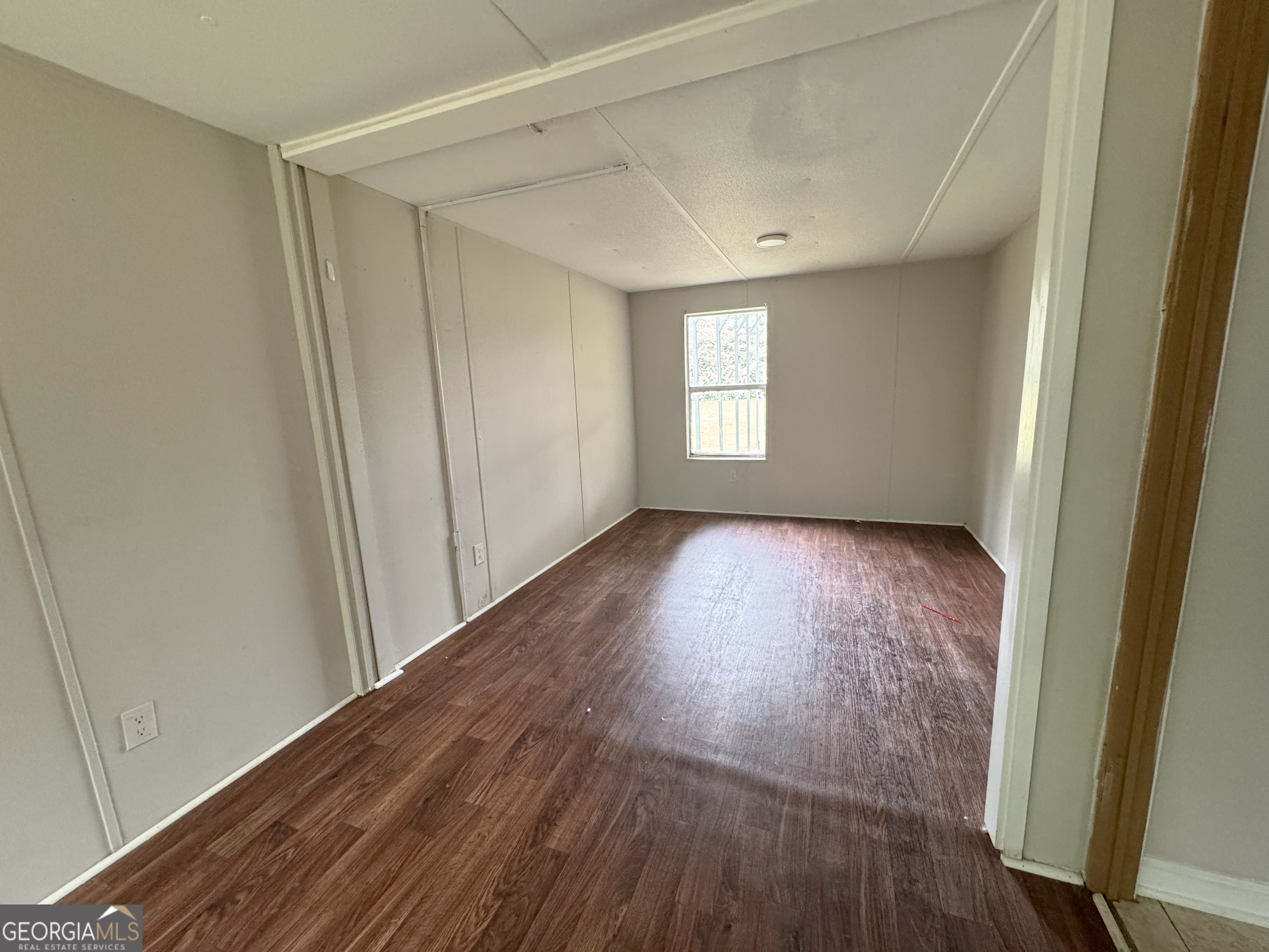 877 West Rushing Road Register, GA 30452 - Photo 15 of 18 a view of hallway with window and wooden floor