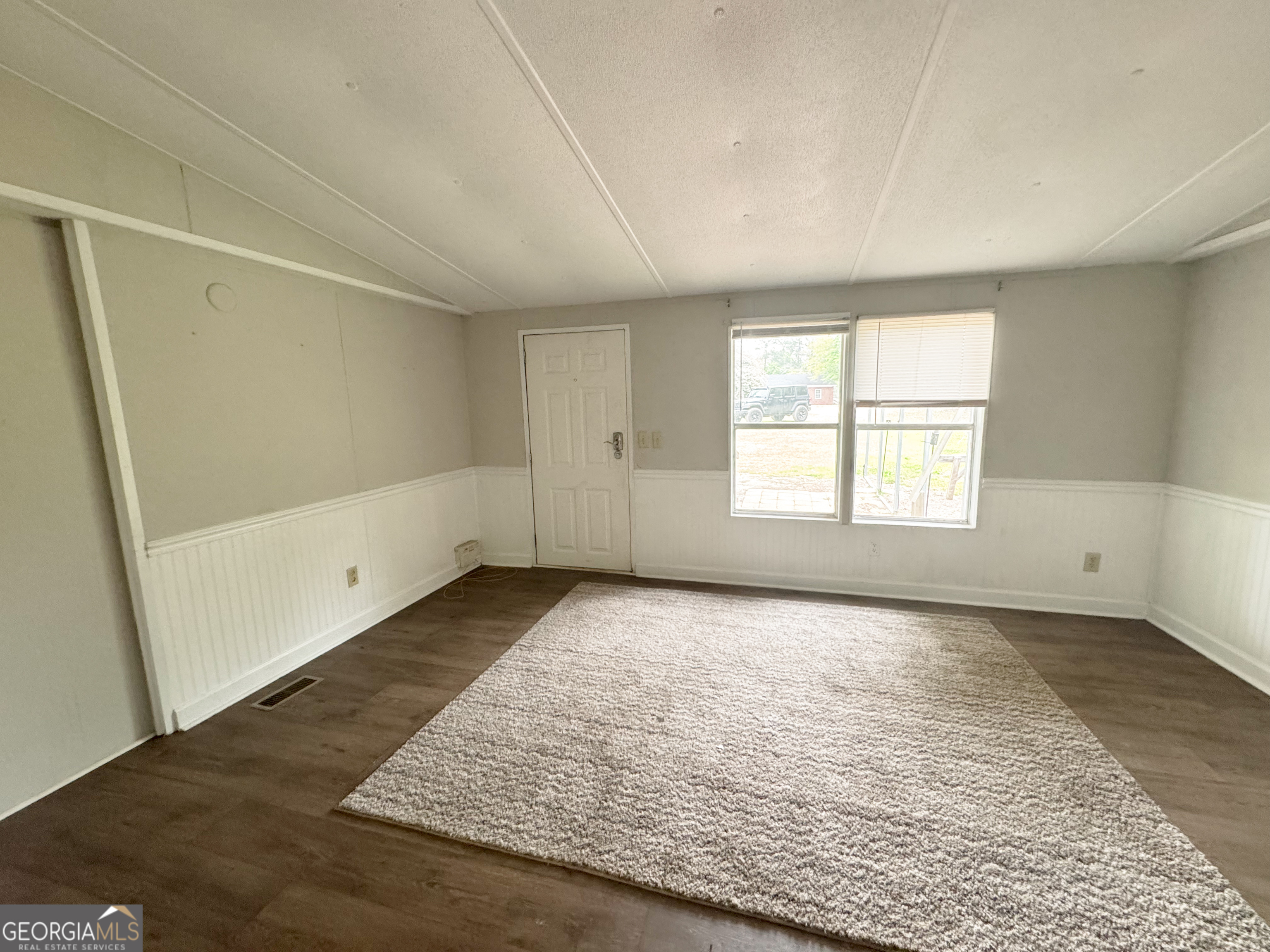 877 West Rushing Road Register, GA 30452 - Photo 16 of 18 an empty room with wooden floor and windows