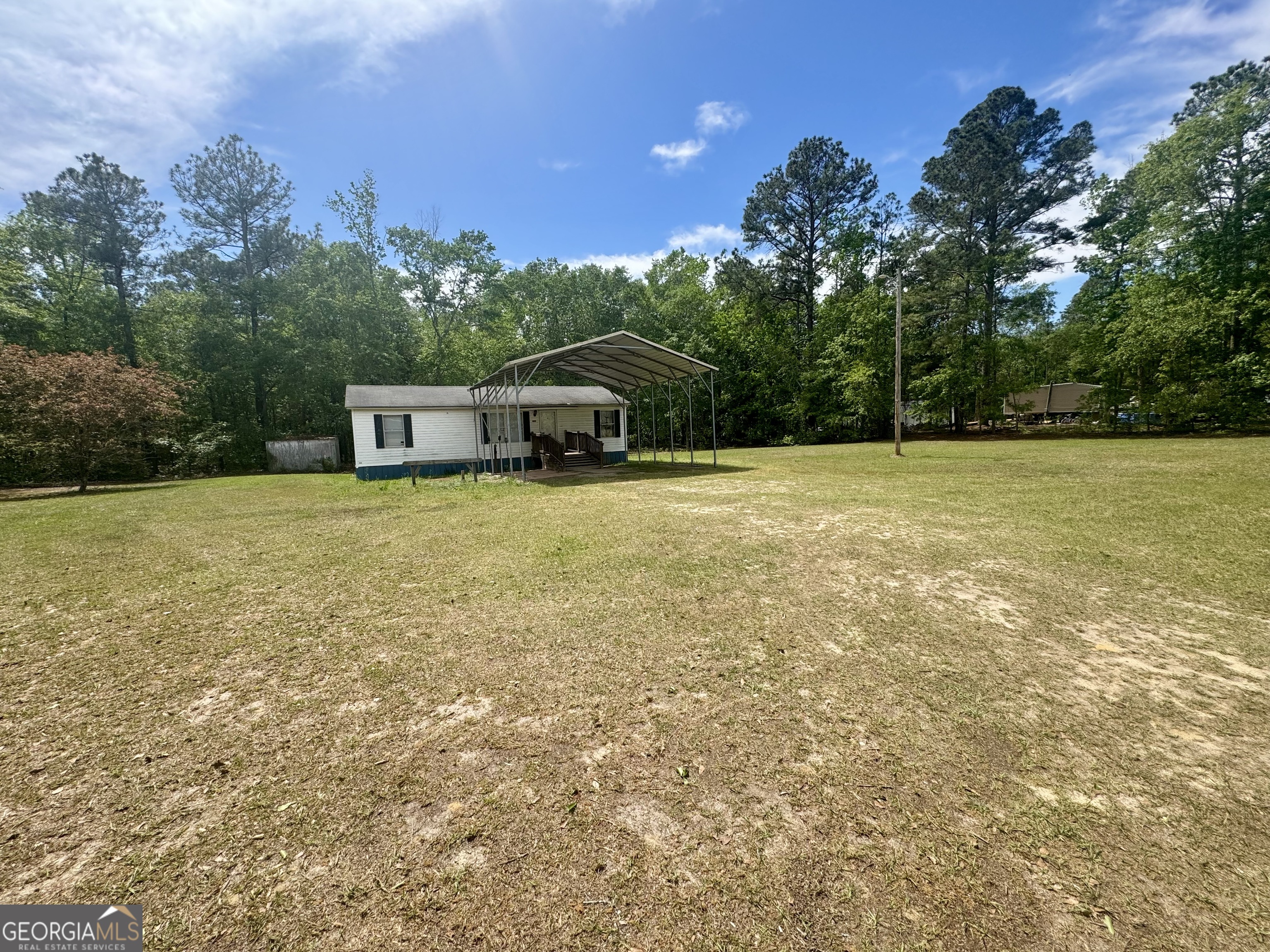 877 West Rushing Road Register, GA 30452 - Photo 18 of 18 a view of a large tree with an outdoor space and seating area