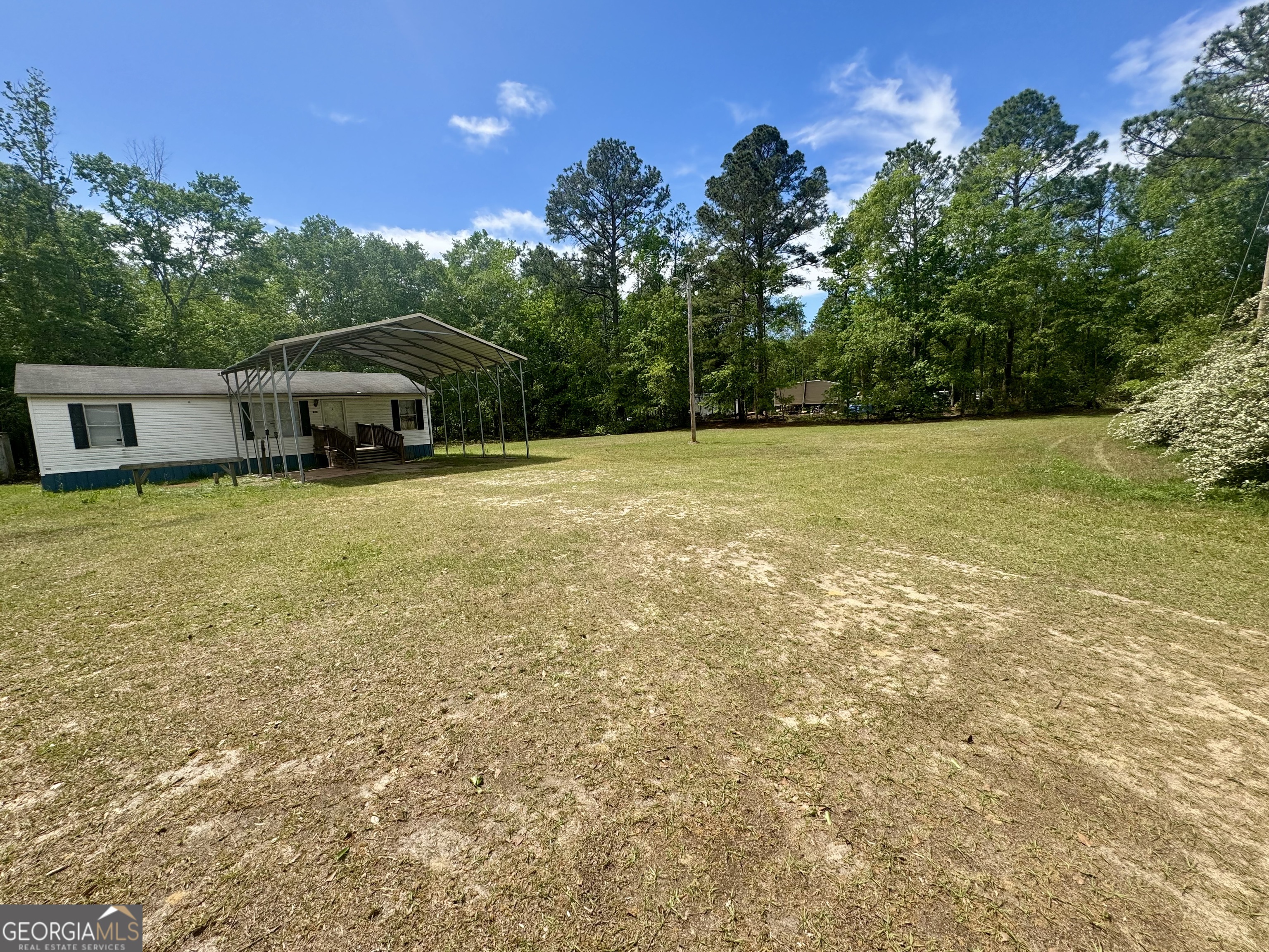 877 West Rushing Road Register, GA 30452 - Photo 4 of 18 a view of a terrace with chairs and a yard