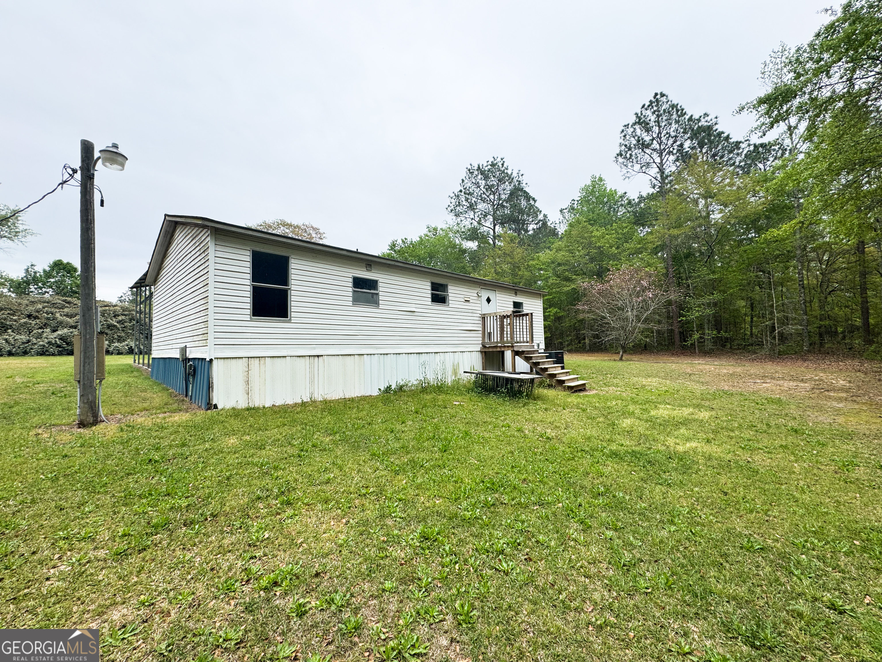 877 West Rushing Road Register, GA 30452 - Photo 7 of 18 a view of a backyard with a garden and entertaining space