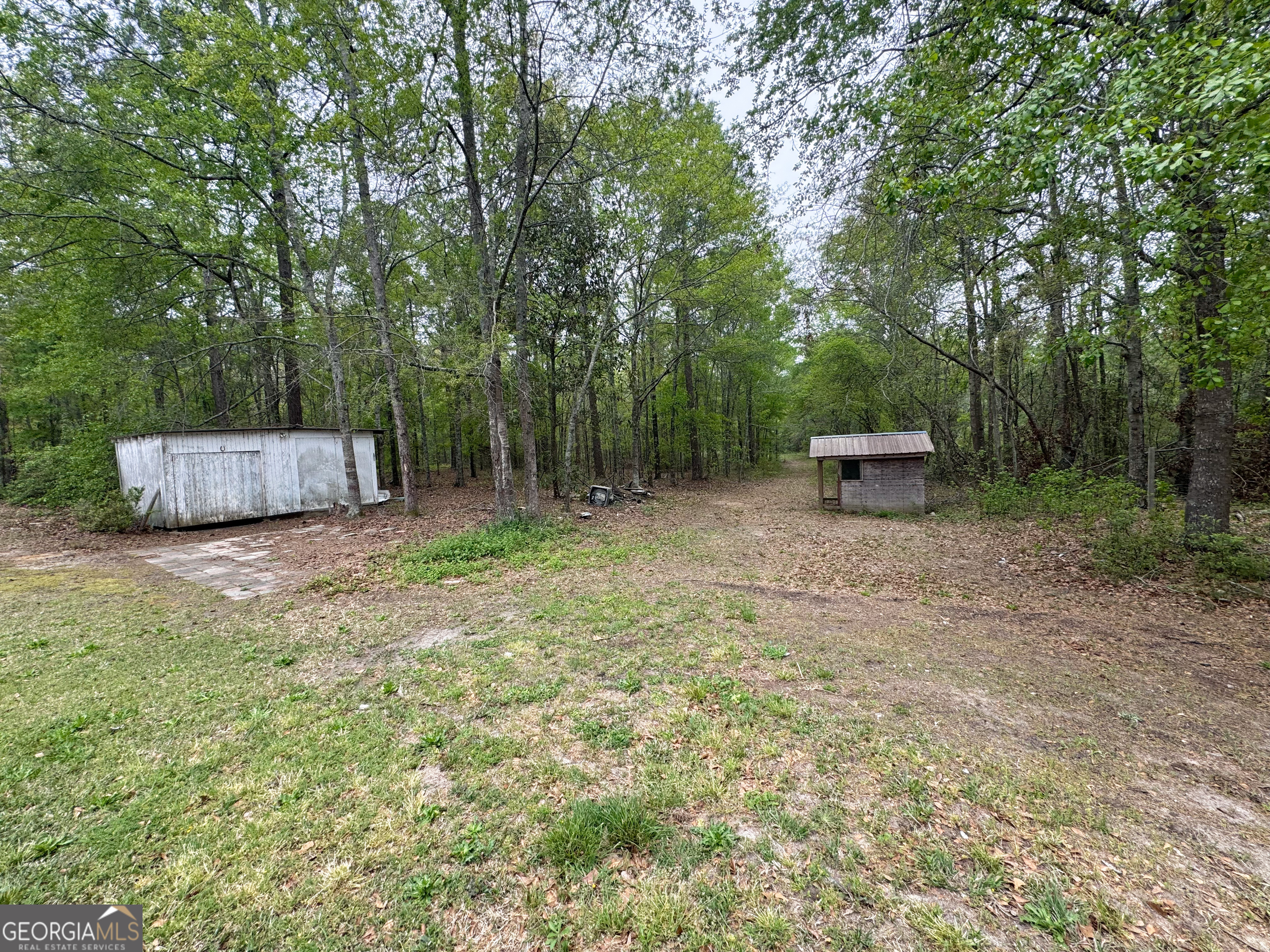 877 West Rushing Road Register, GA 30452 - Photo 8 of 18 a backyard of a house with table and chairs