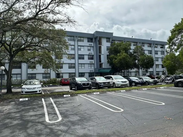 a kitchen with a sink a refrigerator and cabinets