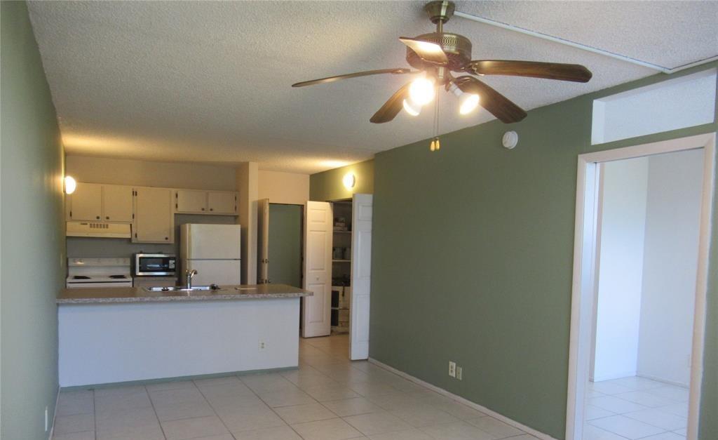 2401 Riverside Drive, Unit 311B Coral Springs, FL 33065 - Photo 7 of 12 a view of a kitchen with a refrigerator and microwave