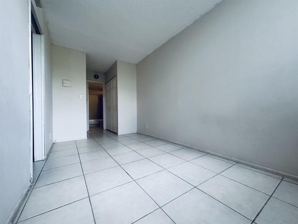 2401 Riverside Drive, Unit 311B Coral Springs, FL 33065 - Photo 10 of 12 an empty room with a fireplace