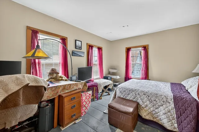 a bedroom with a bed and a workspace