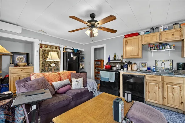 a living room with furniture kitchen and a chandelier