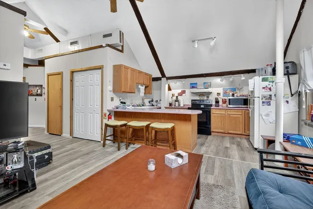 a kitchen with kitchen island a stove a sink and a refrigerator