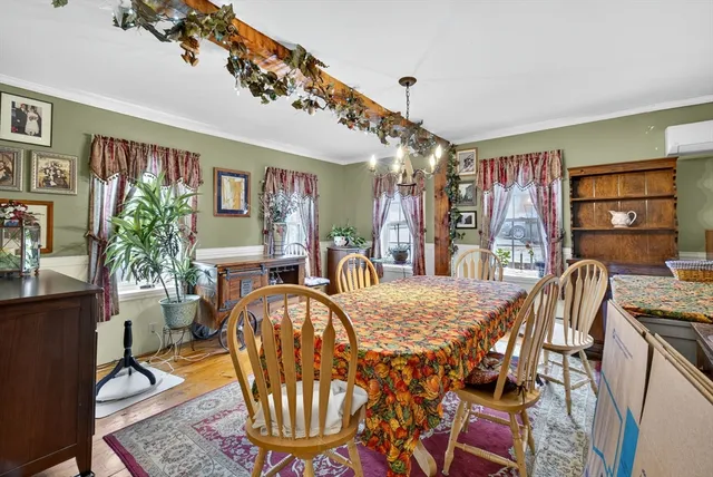 a view of a dining room with furniture and chandelier