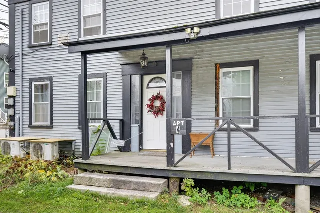 a view of house with a window and potted plants