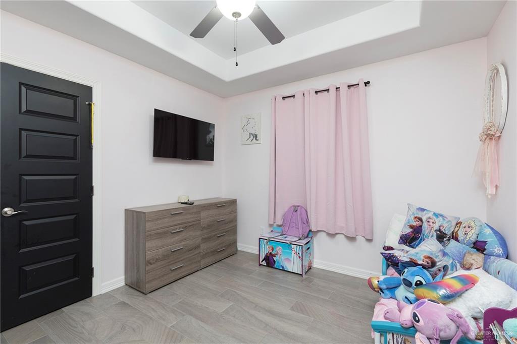 503 Northern Dancer Avenue Edinburg, TX 78539 - Photo 12 of 34 a bedroom with a bed and a television in it