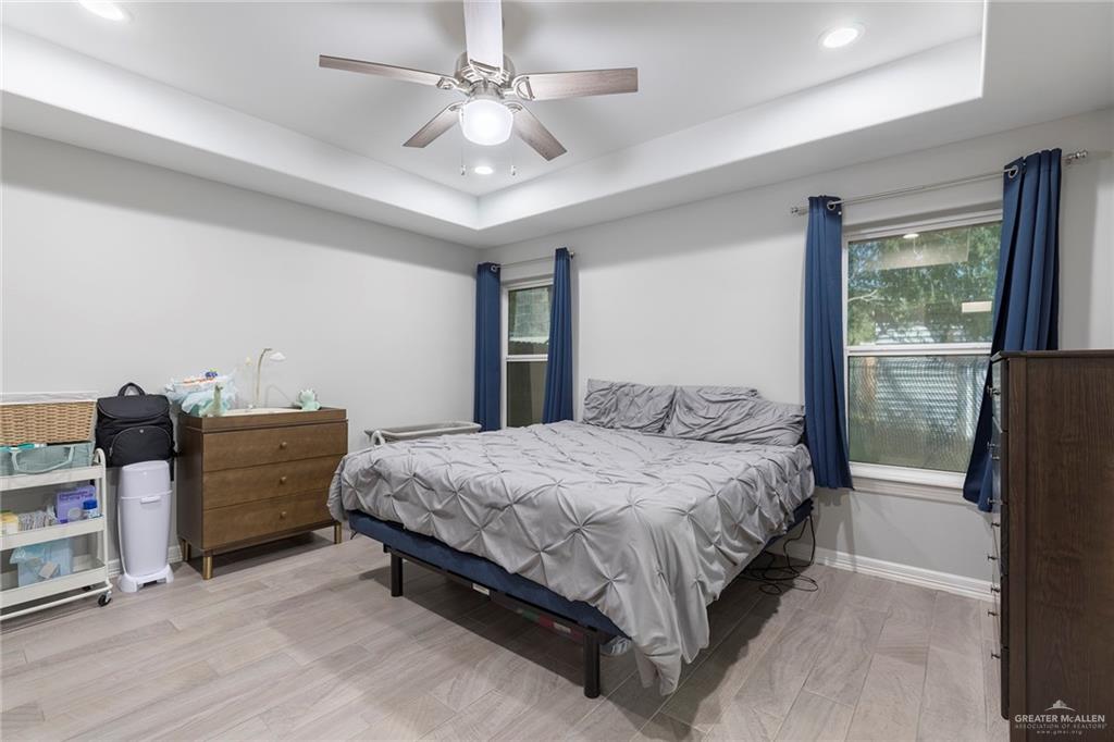 503 Northern Dancer Avenue Edinburg, TX 78539 - Photo 17 of 34 a bedroom with a bed and a chandelier