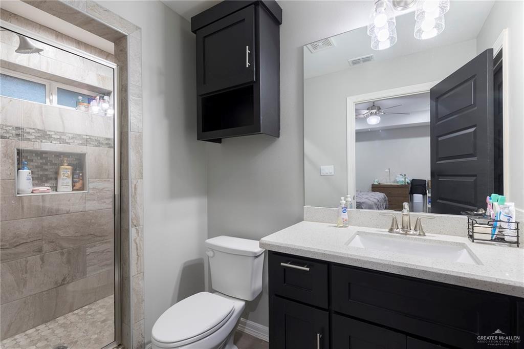 503 Northern Dancer Avenue Edinburg, TX 78539 - Photo 4 of 34 a bathroom with a sink a toilet and mirror