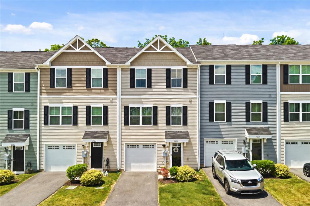 An inviting facade with multiple homes, each boasting a well-maintained driveway and appealing landscaping.