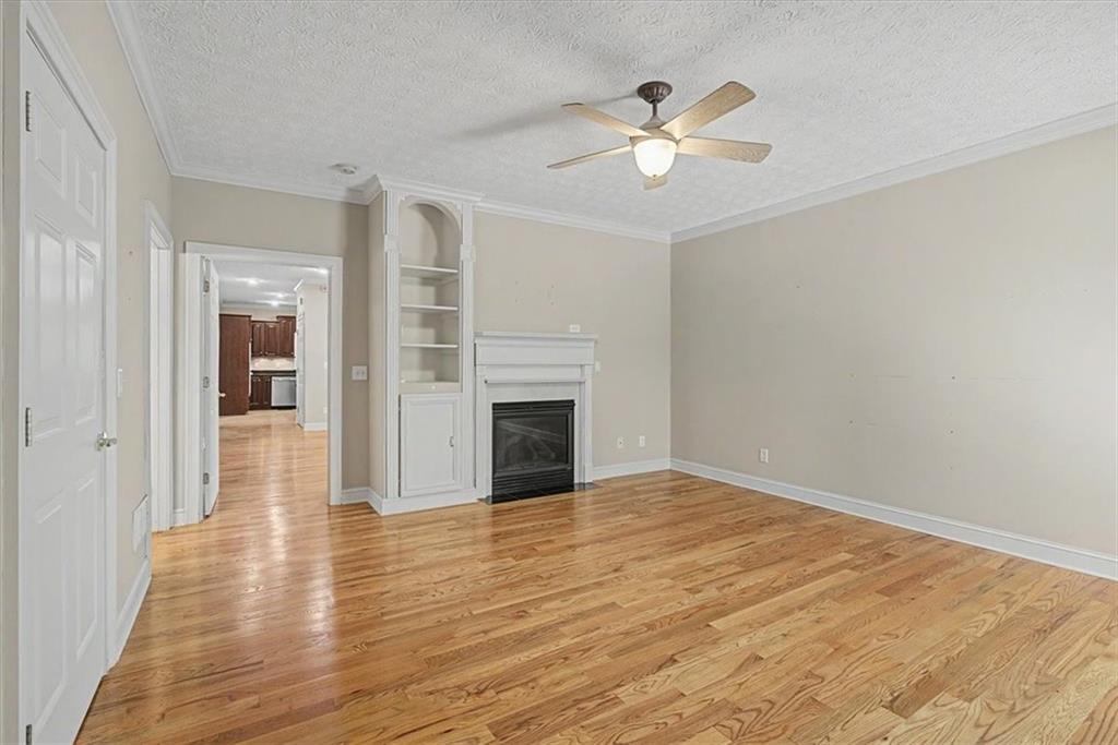 1136 Cole Lake Road Dallas, GA 30157 - Photo 31 of 72 wooden floor in an empty room with a chandelier fan