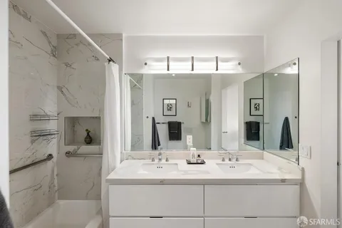 a bathroom with a double vanity sink and a mirror