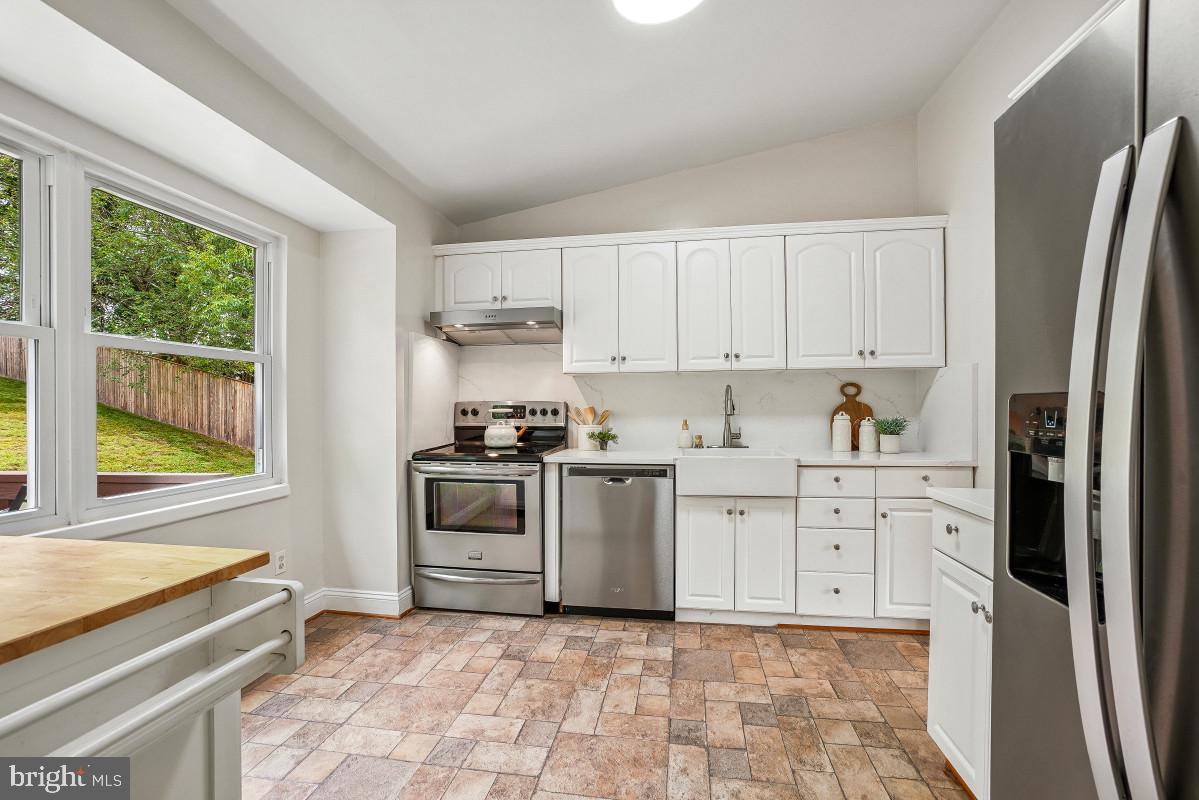 827 Caddington Avenue Silver Spring, MD 20901 - Photo 14 of 45 a kitchen with stainless steel appliances a stove a sink and a refrigerator