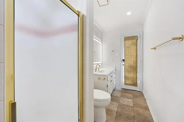 a bathroom with a granite countertop toilet and a sink