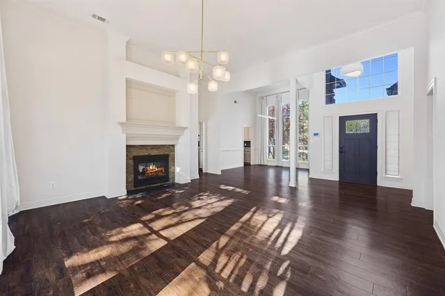 a view of a livingroom with wooden floor and a fireplace