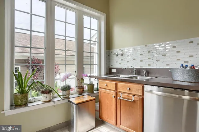 a kitchen with granite countertop a sink and a window