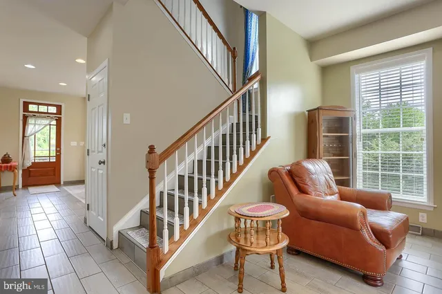 a balcony with furniture and a potted plant