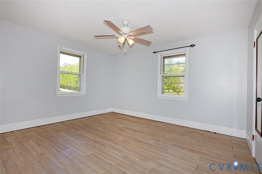 9903 Boze Road Ford, VA 23850 - Photo 19 of 45 a view of an empty room with wooden floor and a window