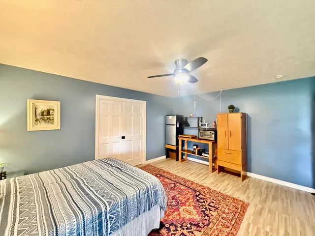 a view of a room with wooden floor and furniture