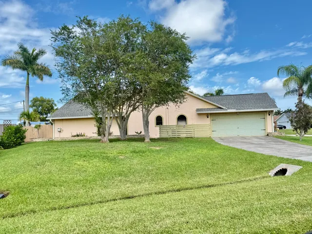 a view of a backyard with sitting area
