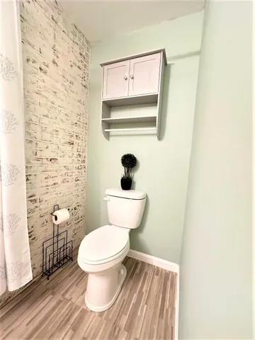 a bathroom with a toilet and a mirror