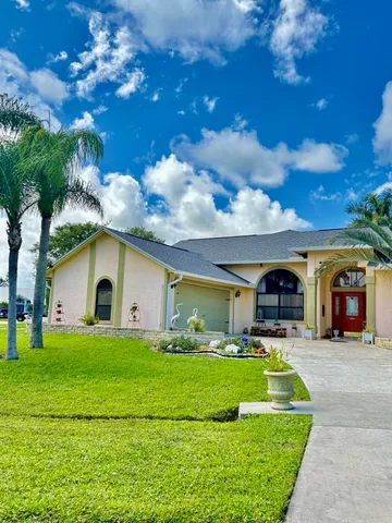 a front view of house with yard and green space