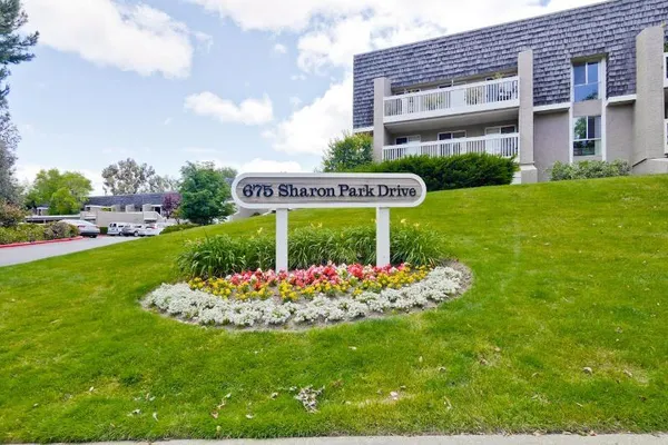 a garden with flowers and brick wall