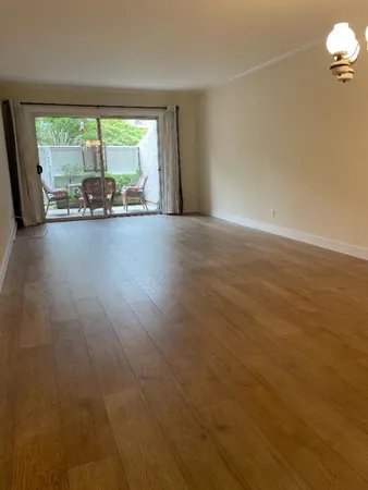 a view of a room with furniture and a large window