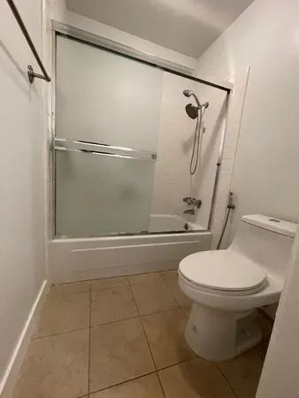 a bathroom with a toilet and a shower