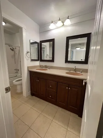 a bathroom with a double vanity sink and mirror