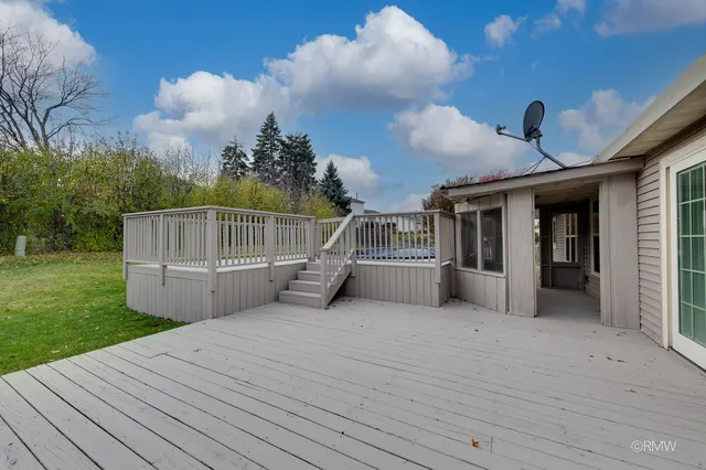 a view of a deck with a big yard