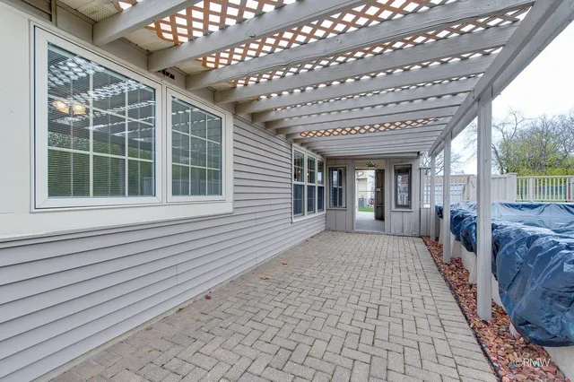 a spacious bedroom with a large window and a balcony
