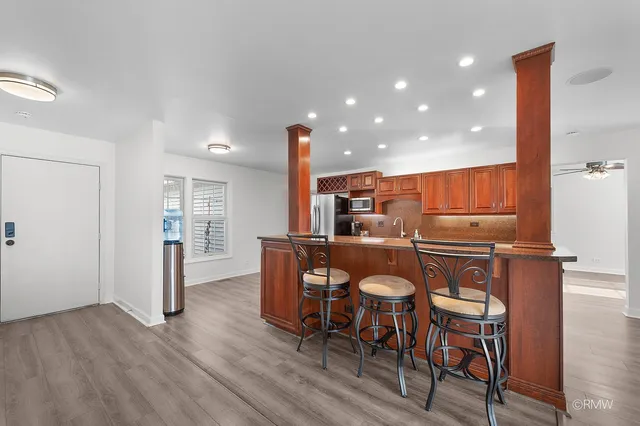 a view of a dining room with furniture and wooden floor