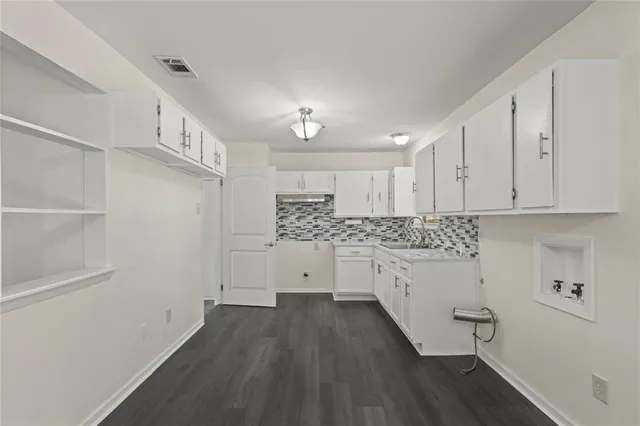a room with cabinets and wooden floor