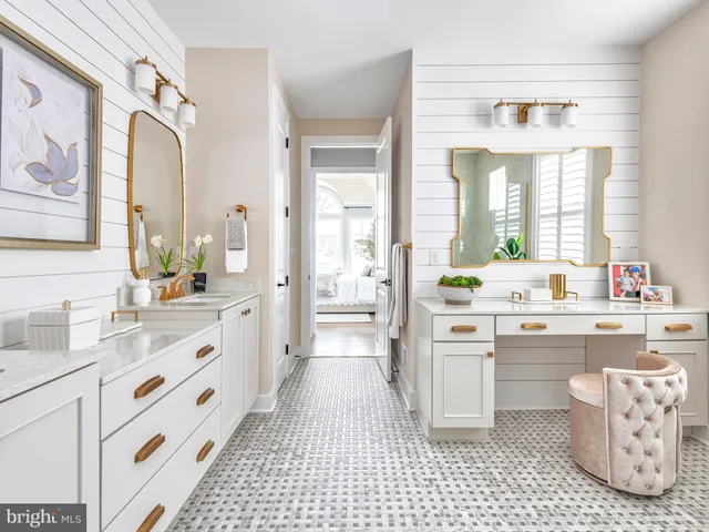 a large white bathroom with a sink a large mirror and a bathtub