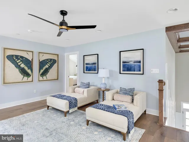 a spacious bedroom with two beds and painting on the wall