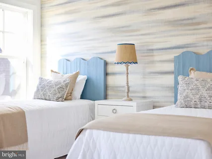 a bedroom with a bed and a lamp