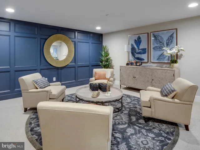 a living room with furniture and a mirror