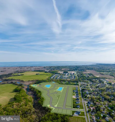 an aerial view of a houses with a yard
