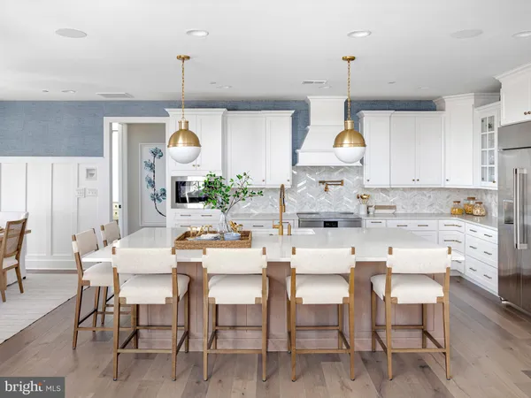a dining room with furniture a chandelier and kitchen view