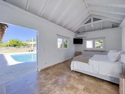 a bedroom with a bed and a night stand with lamp