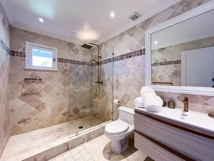 a bathroom with a sink a toilet and shower