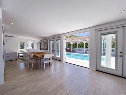 a view of a dining room with furniture and wooden floor
