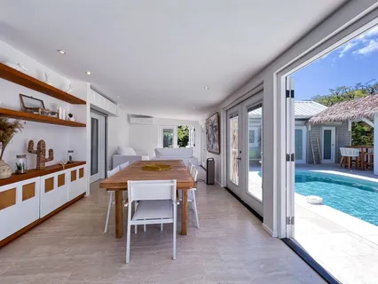 a dining room with furniture and a floor to ceiling window